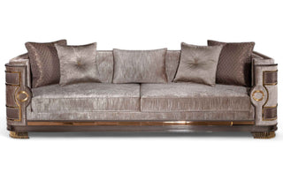 Luxurious Mimosa Chester sofa with plush upholstery in a metallic taupe finish, featuring deep cushions, ornate wooden armrests with gold accents, and matching decorative pillows, designed by Ali Guler Furniture.